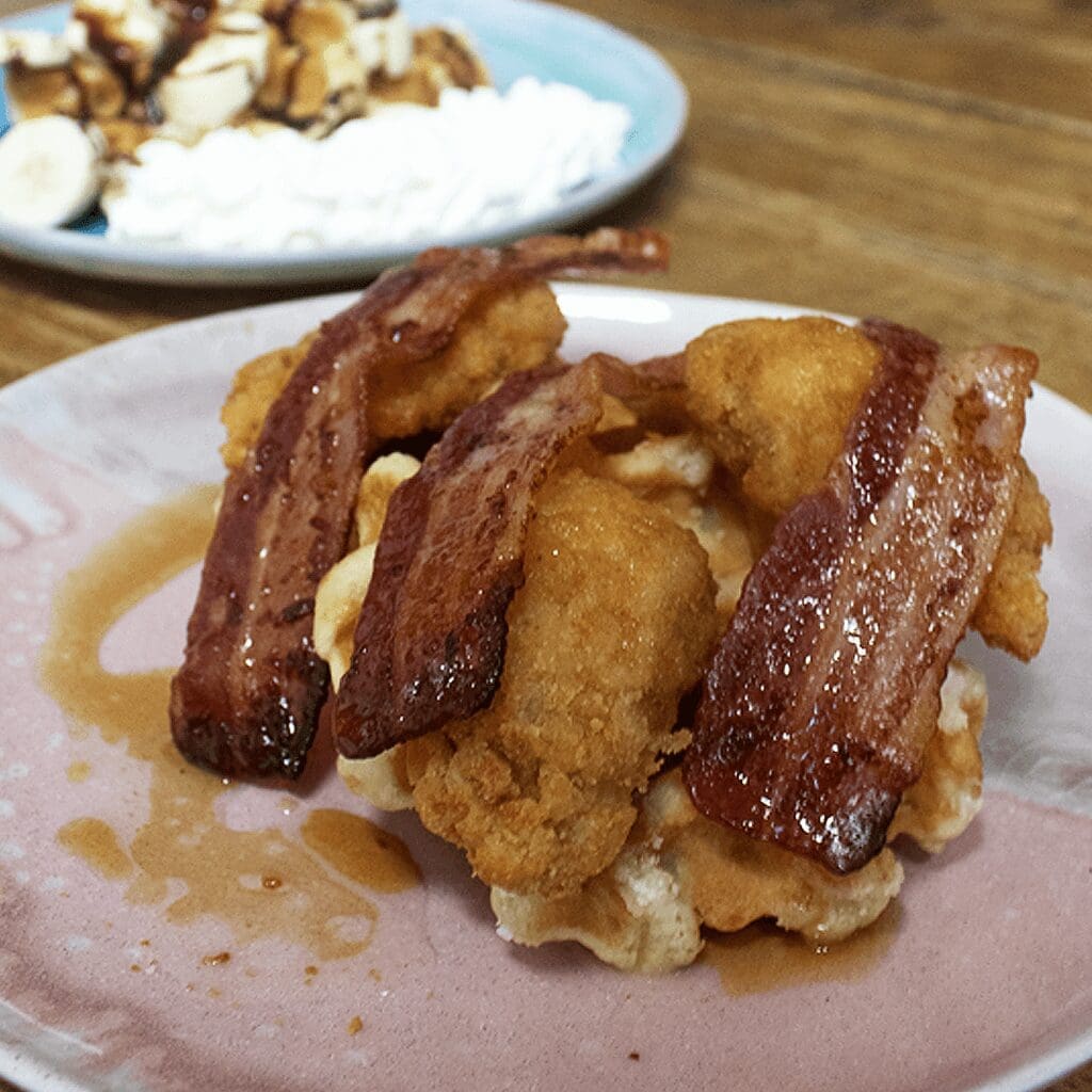 This is a savoury waffle topped with bacon, chicken and maple syrup waffle