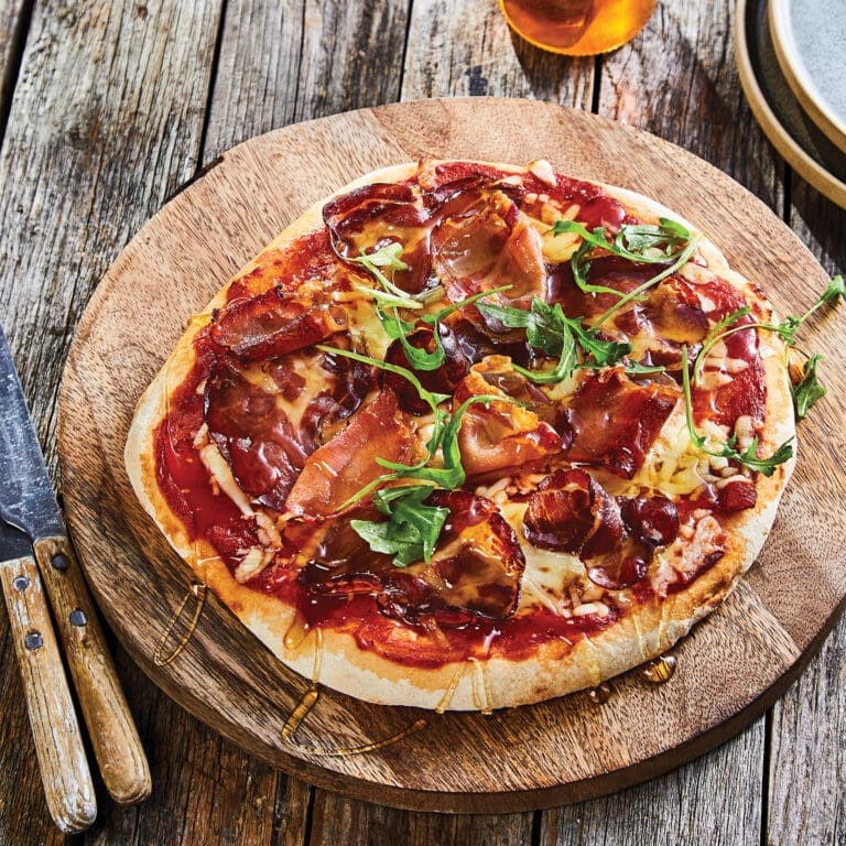 Honeyed hog pizza on a board